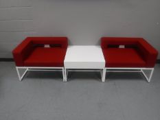 A contemporary triple section settee with coffee table on metal legs