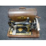 A vintage cased hand Singer sewing machine