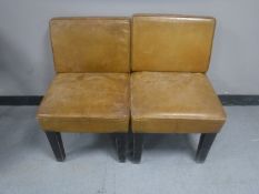 A pair of mid 20th century tan leather chairs