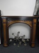 A mahogany effect fire surround and two brass chandeliers