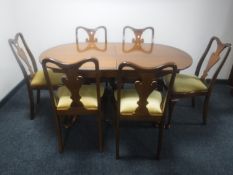 An inlaid mahogany Regency style pedestal dining table with leaf together with a set of six walnut