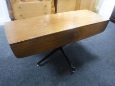 A mid 20th century teak flap sided rise and fall table