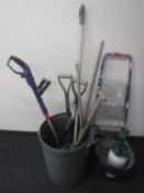 A bin of garden tools, strimmer,