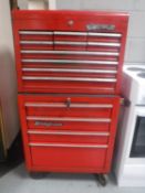 A four drawer Snap-On mechanic's tool chest on wheels containing mechanic's tools and a further