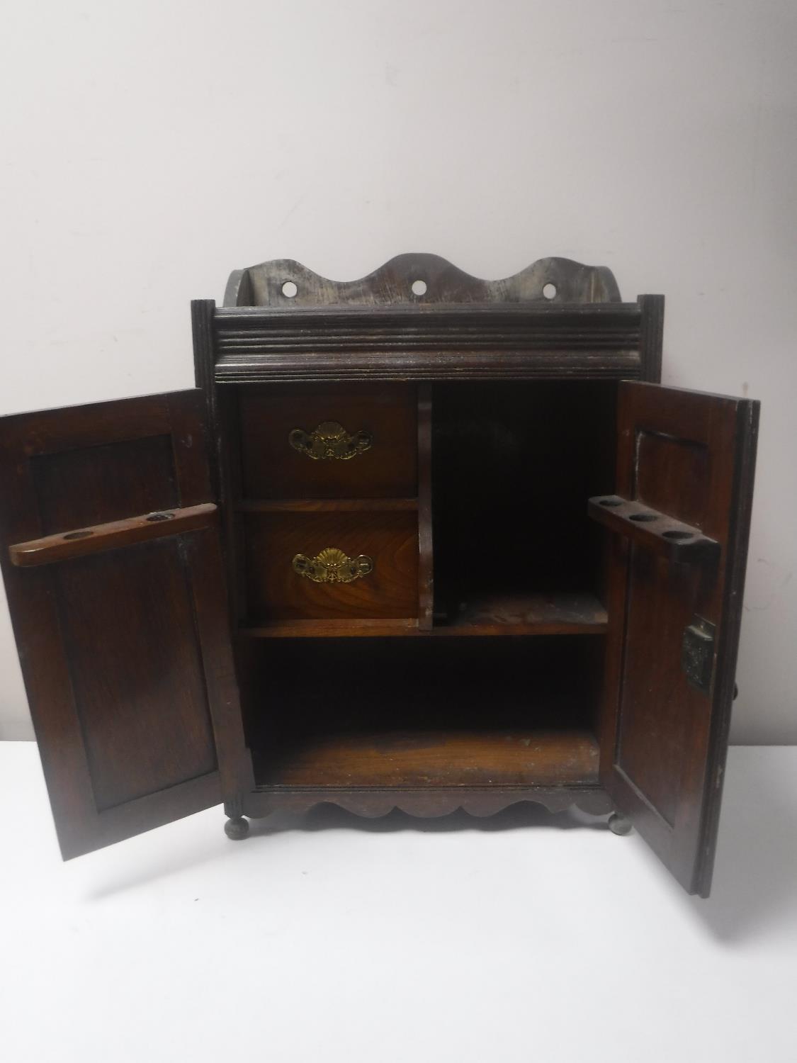 A Victorian oak double door smoker's cabinet with carved panel doors CONDITION REPORT: