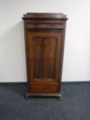 An antique continental mahogany sentry door cabinet fitted two drawers