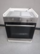 An Indesit electric wall cooker in cupboard