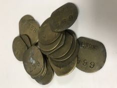 Nineteen vintage brass railway pay check tokens.