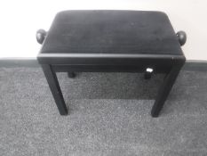 A contemporary adjustable piano stool