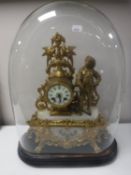 A 19th century gilt brass and alabaster figural mantel clock under and glass dome