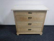 An early 20th century continental pine four drawer chest with marble top