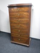 An antique continental mahogany seven drawer chest (feet needing attention)