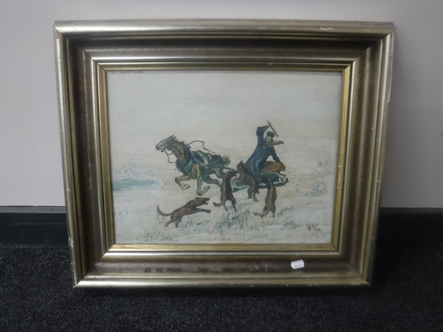 A gilt framed continental oil on board, wolves harassing man on sledge,