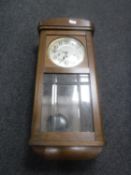 An early 20th century Junghans wall clock with pendulum