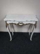 A white and gilt marble topped console table