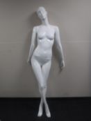 A female shop mannequin and three extra arms