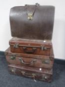 Three vintage luggage cases and a briefcase