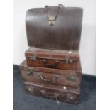 Three vintage luggage cases and a briefcase