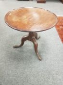 A George III mahogany tripod low table,