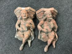 A pair of terracotta figural wall brackets