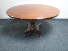An antique continental mahogany oval pedestal table