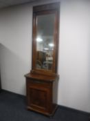 An antique continental inlaid mahogany cabinet with similar hall mirror