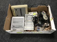 A box of Nintendo entertainment systems with leads and games including James Pond, Mario All Stars,