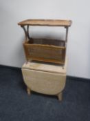 A walnut pie crust edge magazine rack together with a blond oak drop leaf coffee table