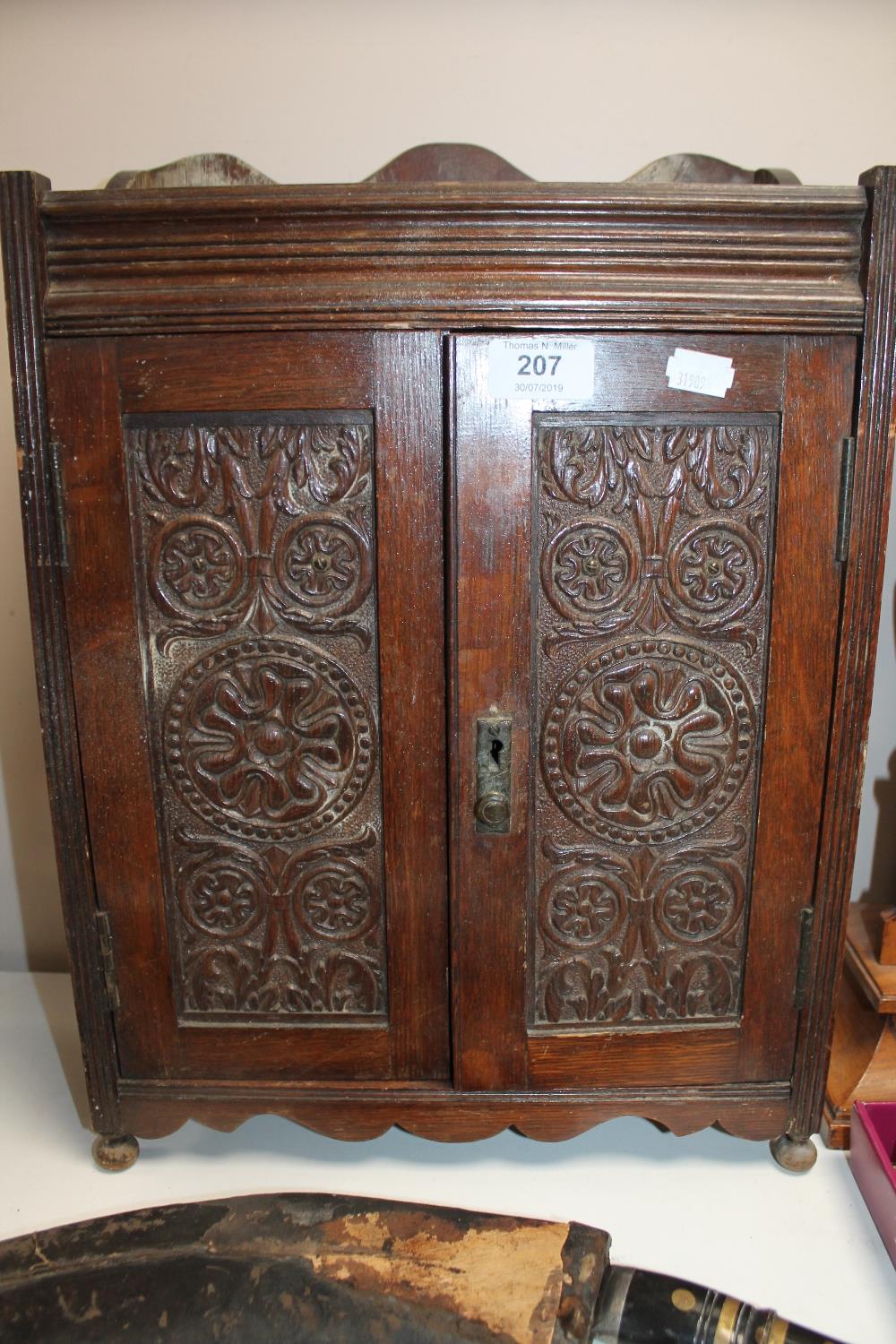 A Victorian oak double door smoker's cabinet with carved panel doors CONDITION REPORT: - Image 2 of 2