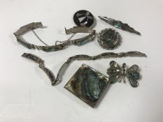 A group of silver and abalone jewellery