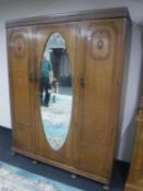 An Edwardian oak triple door wardrobe
