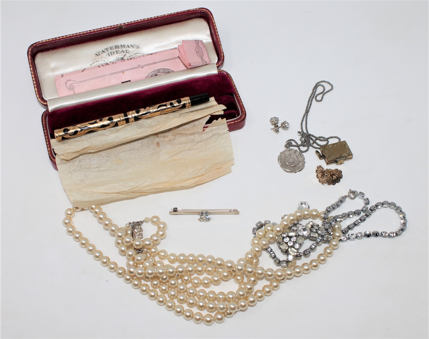 A boxed Waterman's Ideal yellow metal mounted fountain pen, together with a costume pearl necklace,