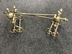 A set of brass Art Nouveau fire dogs together with a set of fire tongs