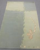 A hand-knotted rug in two-tone green,
