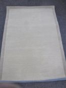 A hand knotted beige rug,