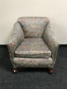 An antique armchair with contemporary upholstery
