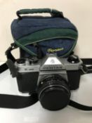 An Asahi Pentax K1000 camera with lens in camera bag