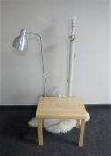 A metal standard lamp together with a metal reading lamp, sheepskin style rug,