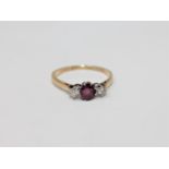 An 18ct gold and platinum set two stone diamond and ruby ring, size Q 1/2.