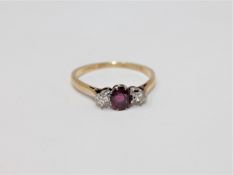 An 18ct gold and platinum set two stone diamond and ruby ring, size Q 1/2.