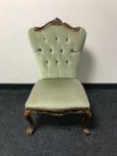 A continental style bedroom chair upholstered in green buttoned dralon