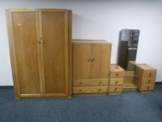 A mid 20th century three piece oak bedroom suite comprising of double door wardrobe,