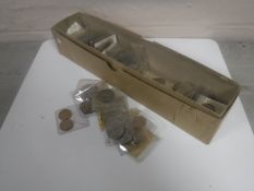 A box containing a quantity of British coins.