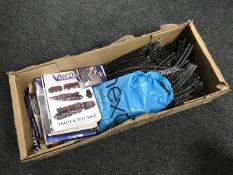 A box containing a quantity of Hornby track together with auction catalogues and booklets relating