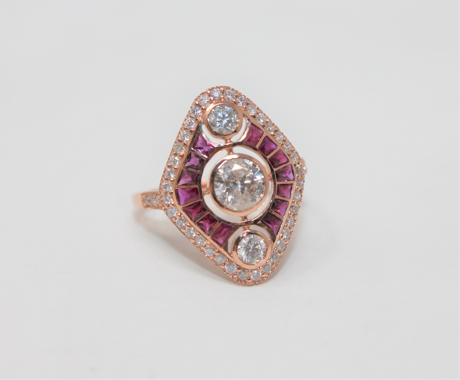 A 14ct rose gold ruby and diamond ring, featuring 1 round brilliant cut diamond 0.