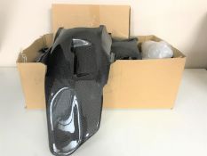 A box containing new-stock motorcycle carbon fibre panels for a GS1200 bike