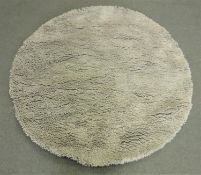 A hand knotted shaggy grey rug,