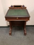 A Victorian mahogany Davenport, width 61 cm, with glass inkwells.