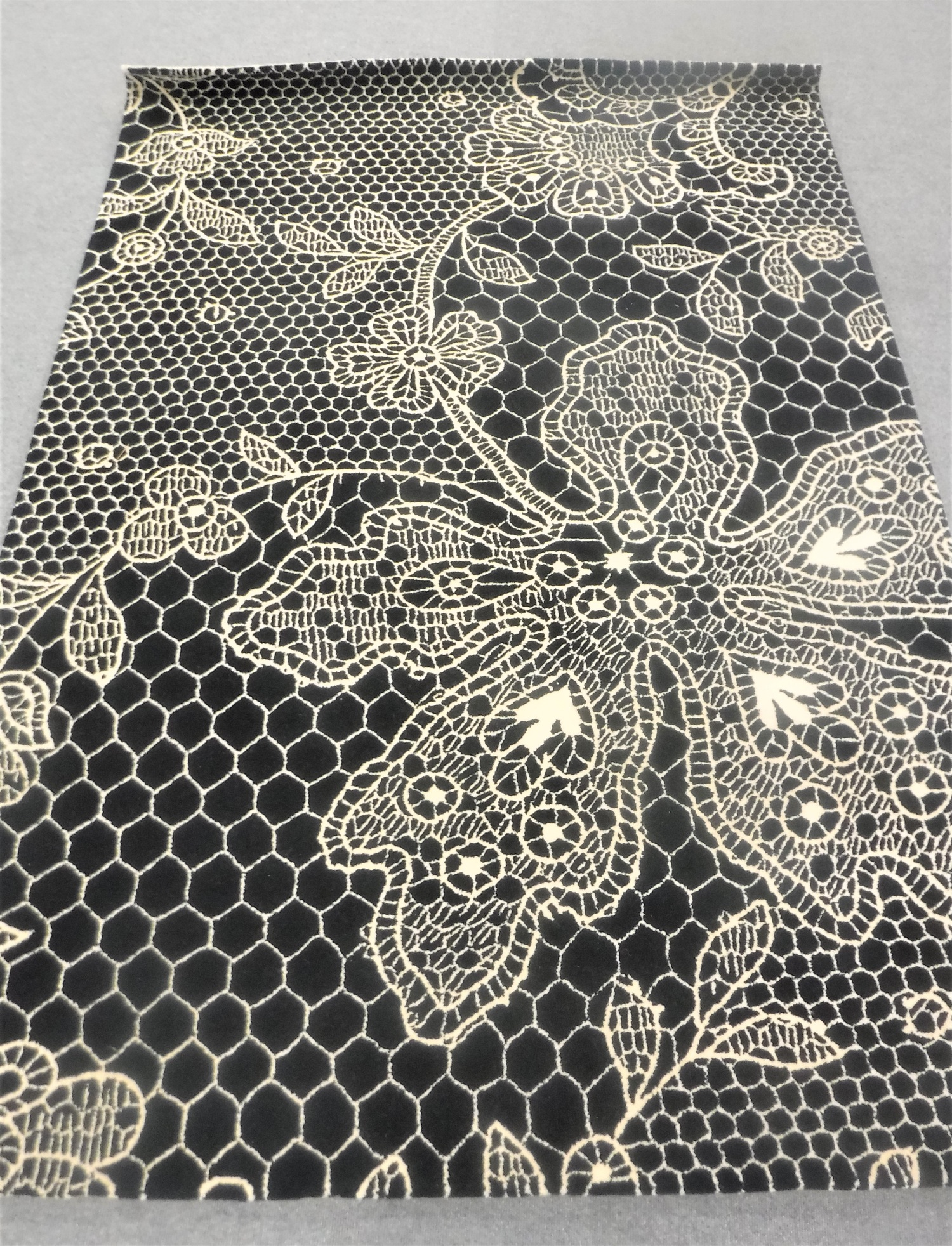 A hand-knotted rug in cream and black,
