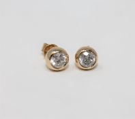 A pair of 14ct yellow gold diamond earrings featuring two round brilliant cut diamonds 1.0ct.